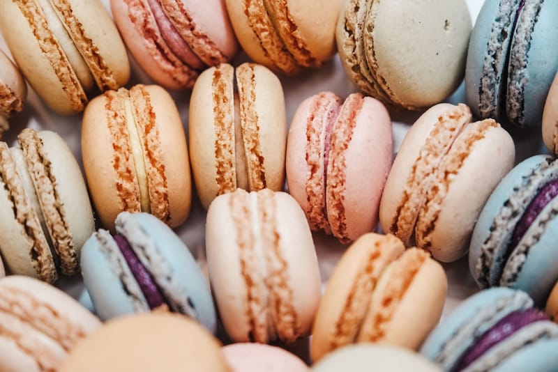 Elegant French macarons in soft pastel colors arranged in a row